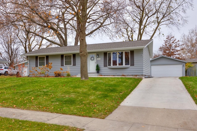 view of front facade with a front yard, a garage, and an outdoor structure