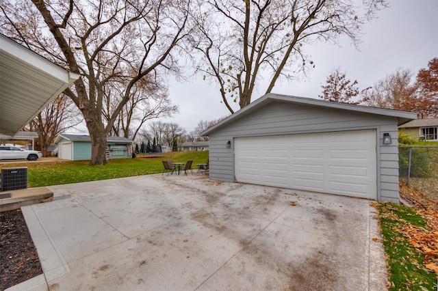 garage with a yard and central AC