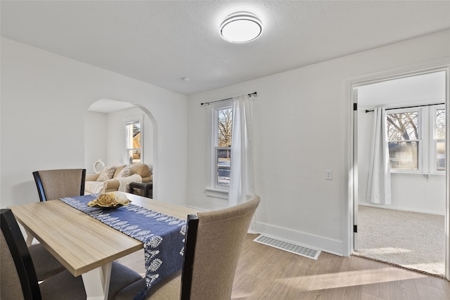 dining area with hardwood / wood-style flooring and plenty of natural light