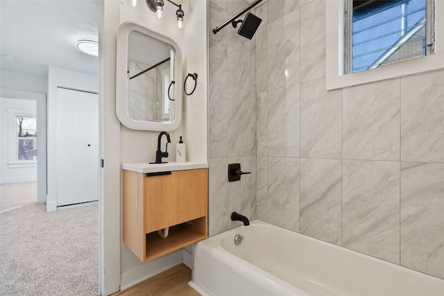 bathroom with vanity and tiled shower / bath combo