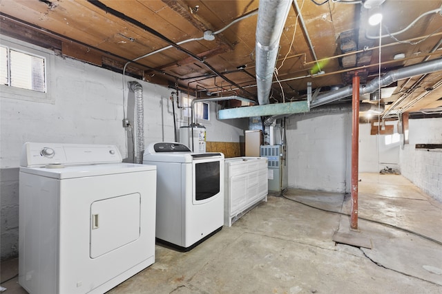 laundry area with water heater and independent washer and dryer