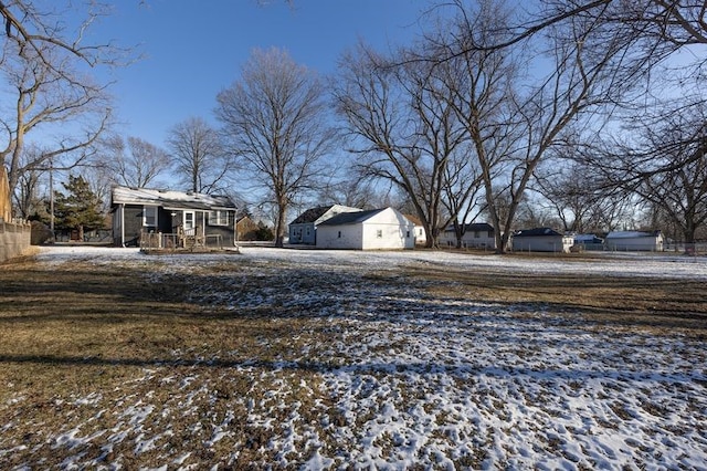 yard layered in snow with covered porch