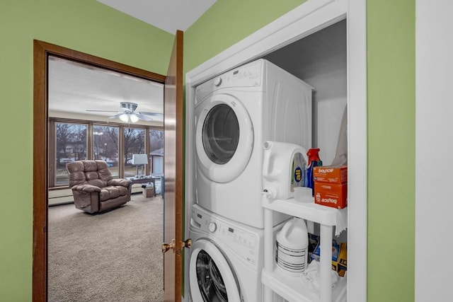 laundry room featuring ceiling fan, carpet flooring, and stacked washer / drying machine