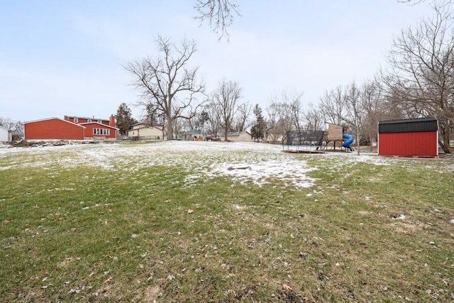 view of yard featuring a playground, a storage shed, and a trampoline