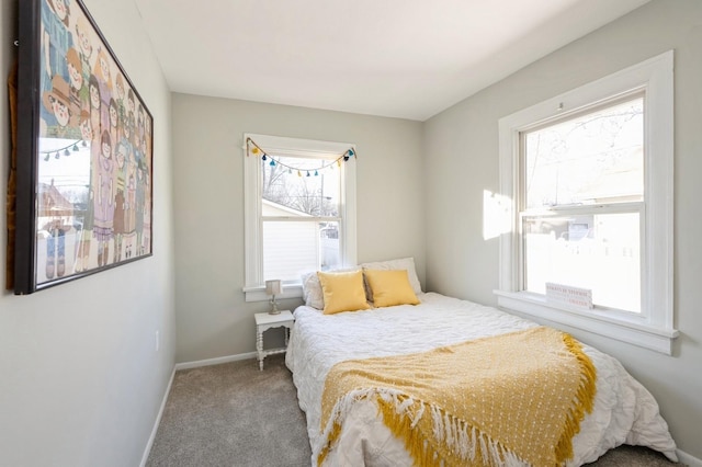 carpeted bedroom featuring multiple windows