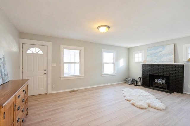 living room with a fireplace and light hardwood / wood-style flooring