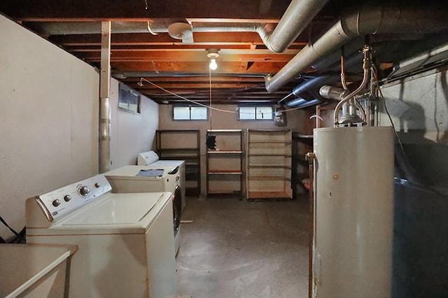 basement with gas water heater and washing machine and clothes dryer