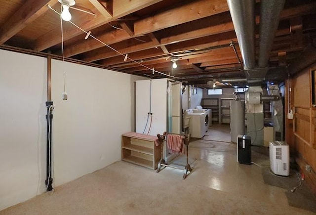 basement with water heater and washing machine and clothes dryer