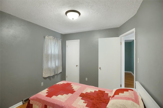 bedroom featuring a textured ceiling