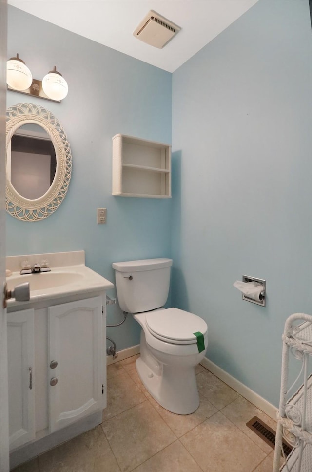 bathroom featuring toilet, vanity, and tile patterned floors