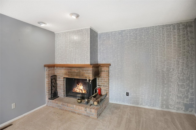 unfurnished living room with a textured ceiling, a brick fireplace, crown molding, and carpet