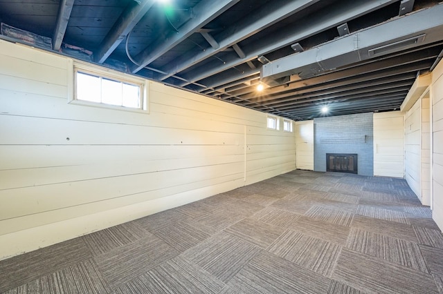 basement with wood walls and carpet floors