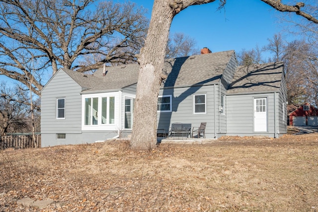 back of property with a patio area and a yard