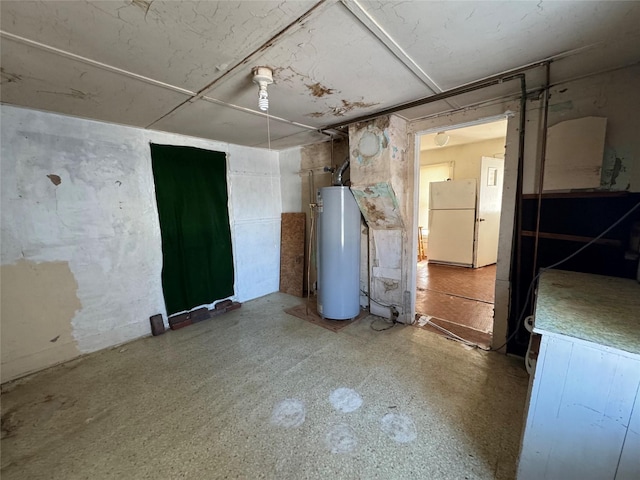 basement featuring white fridge and water heater