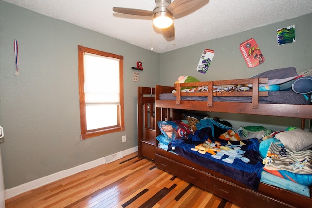 bedroom with hardwood / wood-style flooring and ceiling fan