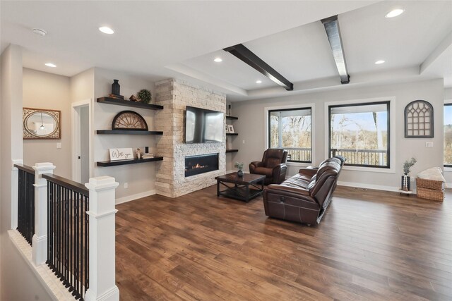 living room with a fireplace, beam ceiling, and dark hardwood / wood-style floors