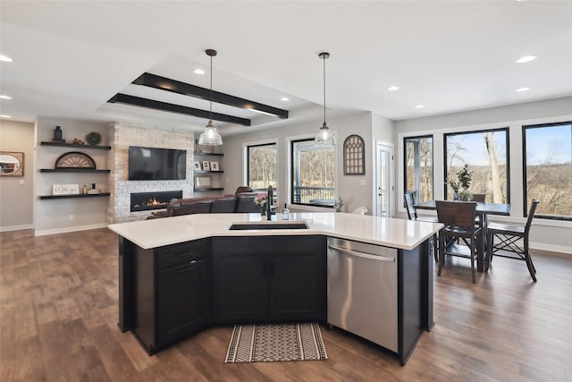 kitchen with sink, pendant lighting, an island with sink, and stainless steel dishwasher