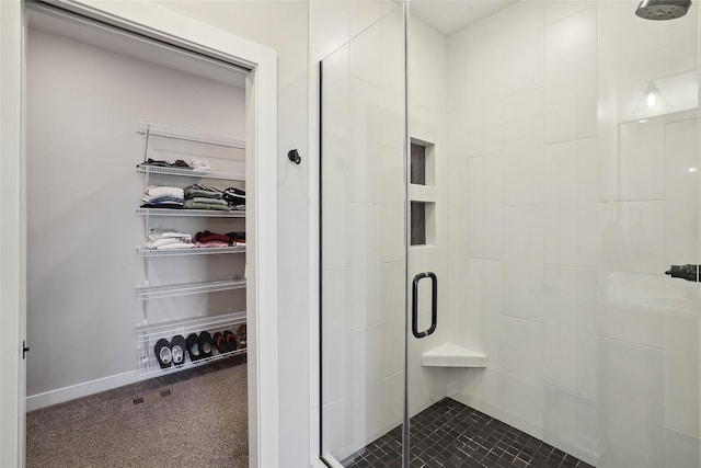 bathroom featuring a shower with door