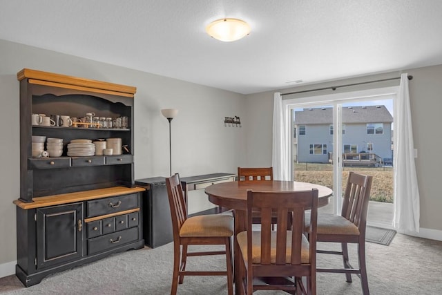 dining room featuring light colored carpet