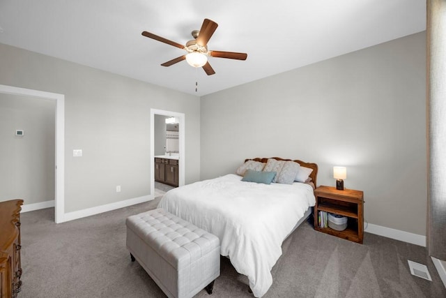 bedroom with ensuite bath, ceiling fan, and carpet