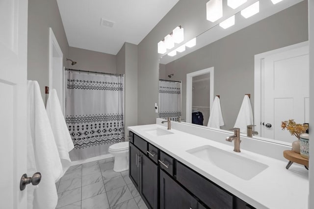 bathroom featuring toilet, a shower with curtain, and vanity