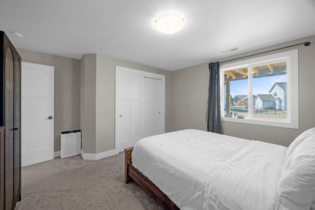 carpeted bedroom with a closet