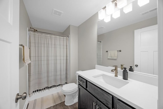 bathroom featuring toilet, vanity, hardwood / wood-style floors, and a shower with curtain