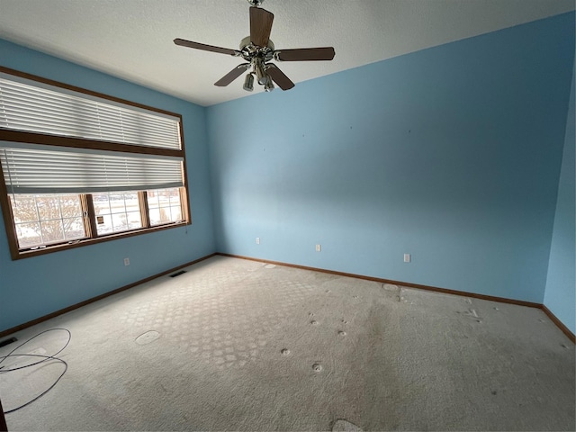 spare room with carpet floors and ceiling fan