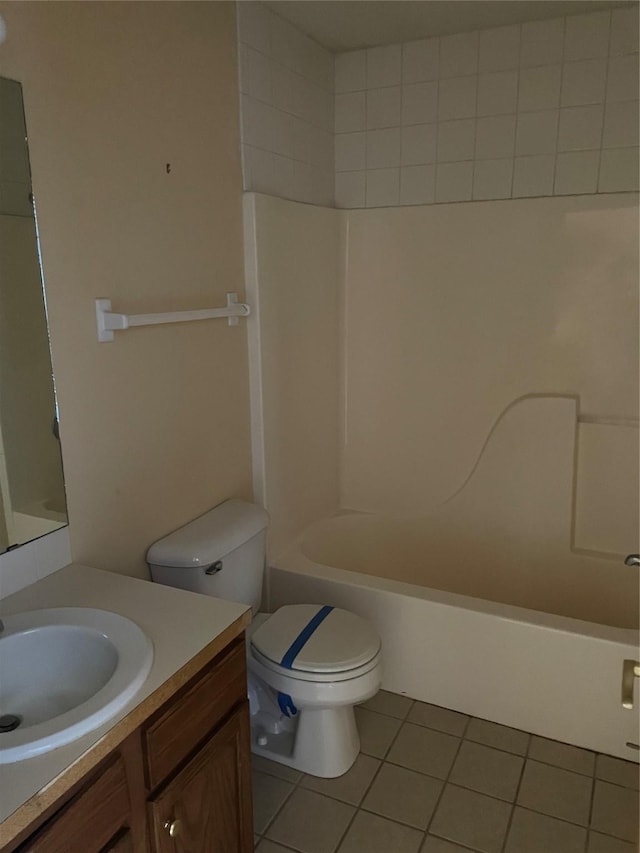 full bathroom featuring toilet, vanity, tile patterned floors, and tub / shower combination