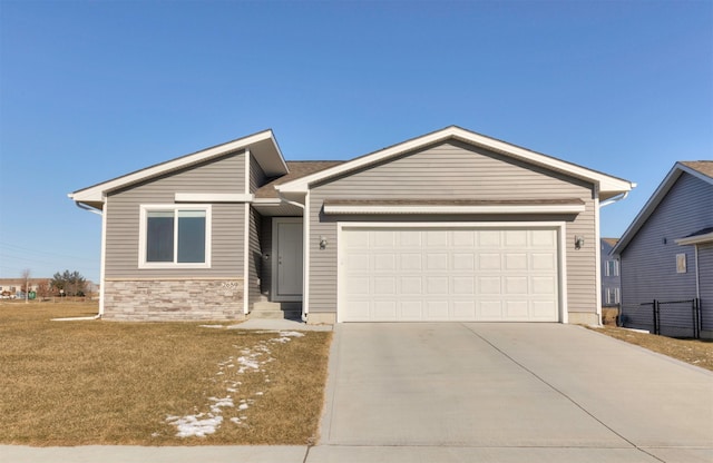 ranch-style home with a front lawn and a garage