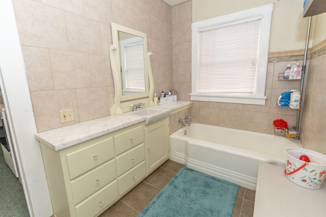 bathroom with tile patterned floors, vanity, tile walls, and a bath