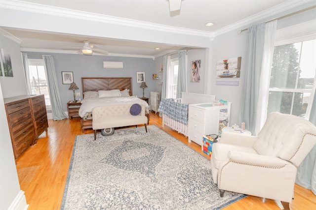 bedroom with ceiling fan, light wood-type flooring, ornamental molding, and radiator heating unit