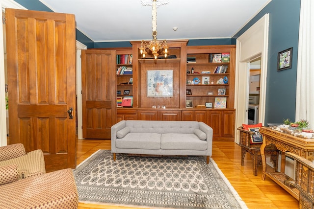 living room with light wood-type flooring and a chandelier