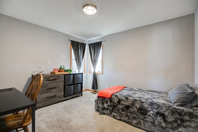 carpeted bedroom with a textured ceiling