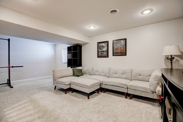 carpeted living room with a textured ceiling