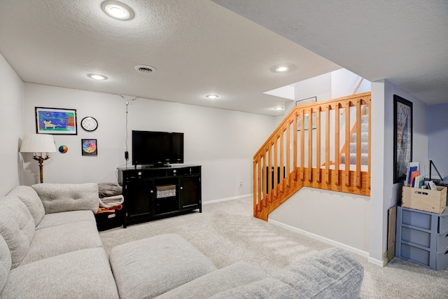 living room with a textured ceiling and light carpet