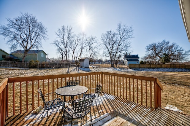 wooden deck with a storage shed