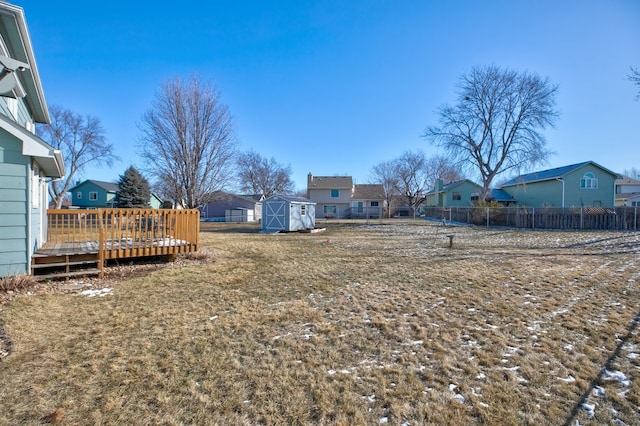 view of yard featuring a deck and a shed