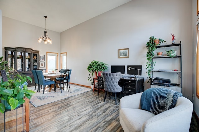 interior space with a notable chandelier, high vaulted ceiling, and hardwood / wood-style flooring