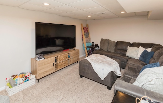 carpeted living room featuring a paneled ceiling