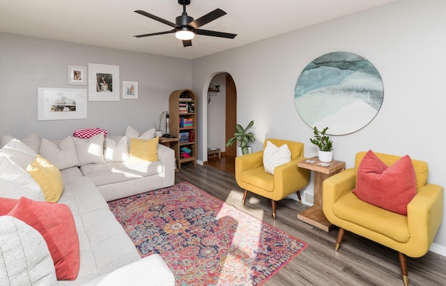 living room featuring ceiling fan and hardwood / wood-style flooring