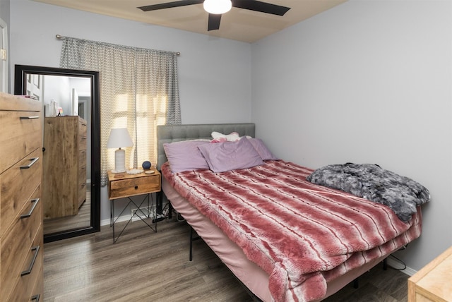 bedroom featuring ceiling fan and dark wood-type flooring