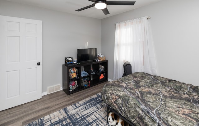 bedroom featuring ceiling fan and dark wood-type flooring