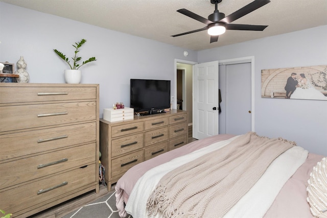 bedroom with ceiling fan and a closet