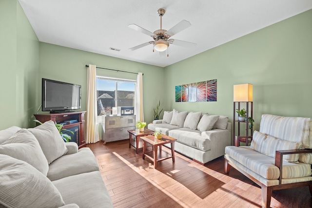 living room with ceiling fan and hardwood / wood-style floors