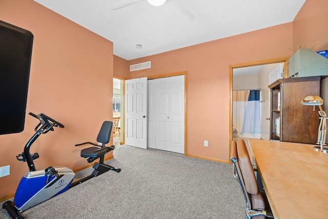 exercise room with ceiling fan and carpet