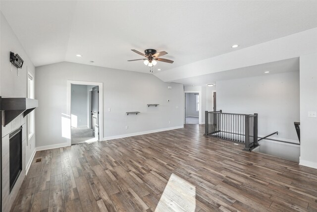 unfurnished living room with wood-type flooring, ceiling fan, and vaulted ceiling