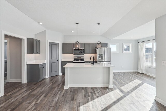 kitchen featuring stainless steel appliances, vaulted ceiling, gray cabinetry, and sink