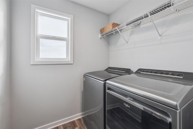 washroom featuring separate washer and dryer and dark wood-type flooring