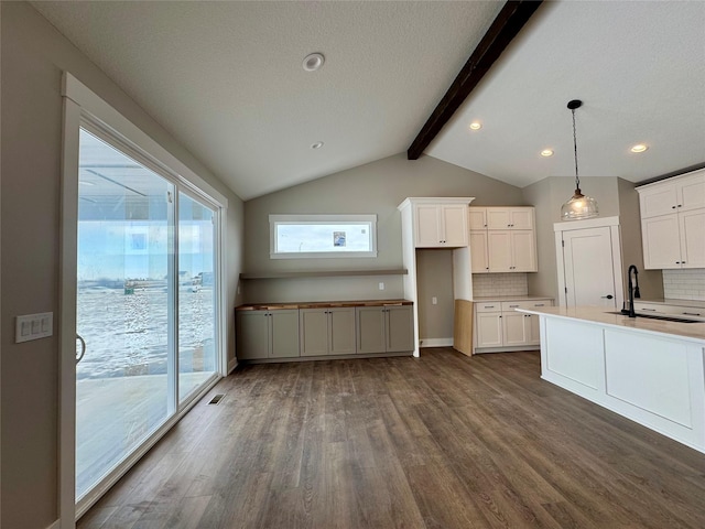 kitchen with decorative light fixtures, tasteful backsplash, dark hardwood / wood-style flooring, white cabinetry, and sink